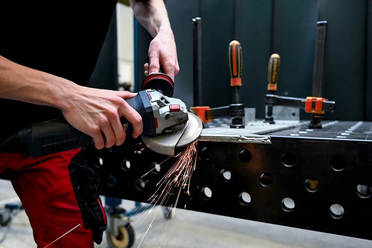Comparison of different angle grinder disc tool types laid out on workbench